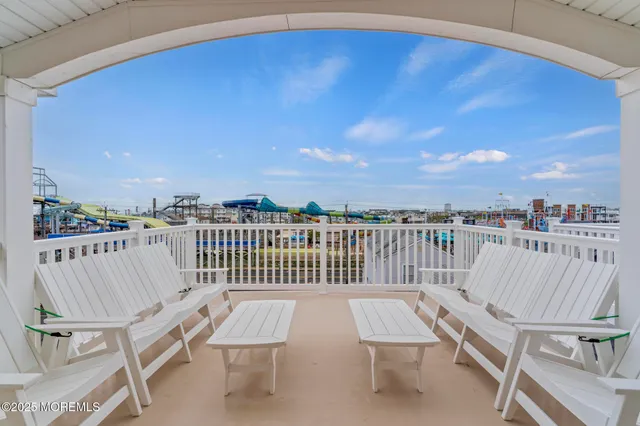 a view of a balcony with wooden benches