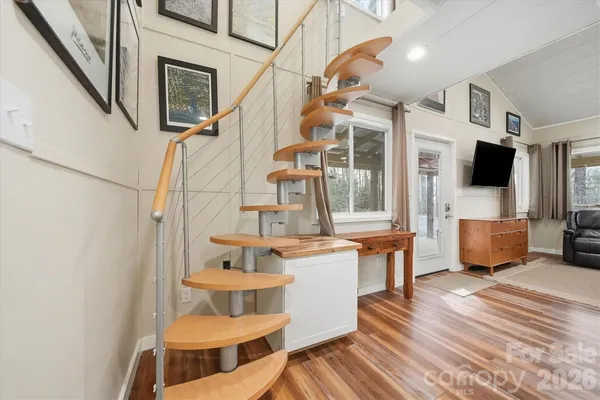a view of living room kitchen with stainless steel appliances granite countertop furniture and fireplace