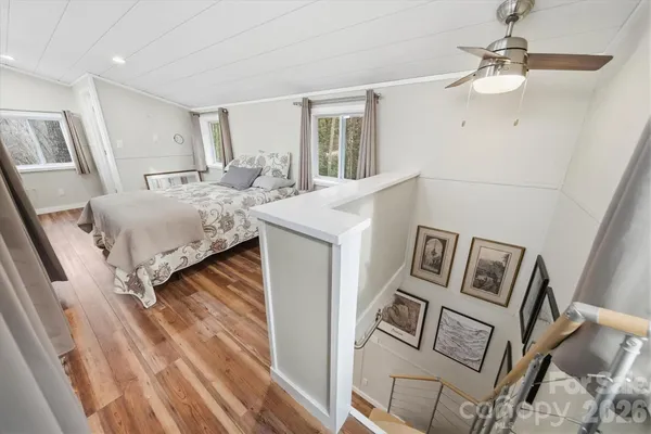 a spacious bedroom with a bed and a mirror