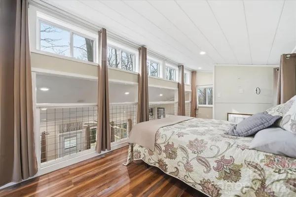 a bedroom with a large bed and a large window