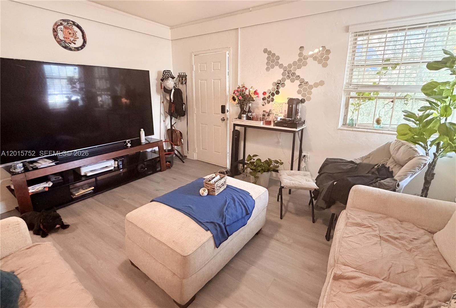 8144 Harding Avenue, Unit 2 Miami Beach, FL 33141 - Photo 2 of 18 a living room with furniture and a flat screen tv