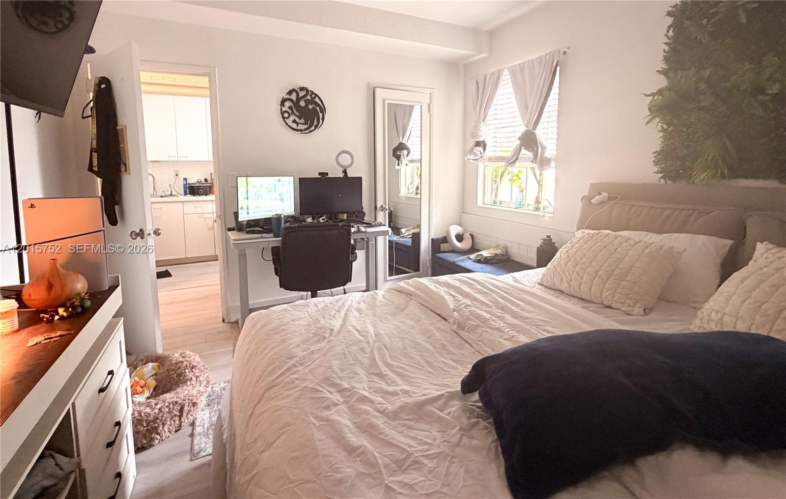 8144 Harding Avenue, Unit 2 Miami Beach, FL 33141 - Photo 7 of 18 a bedroom with a bed and a flat tv screen on dresser