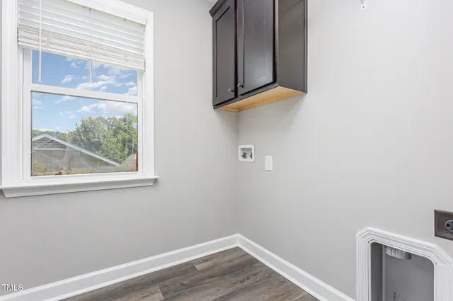 a view of a small space with wooden floor and a window