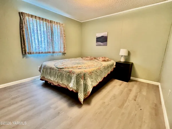 a bed sitting in a bedroom next to a window