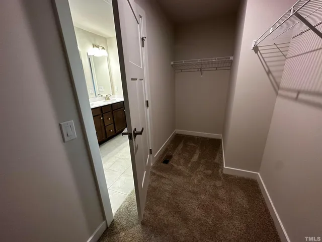 an empty room with closet and mirror