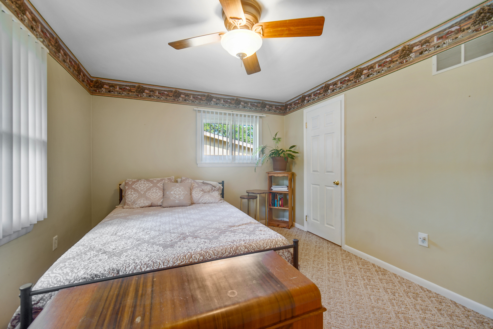 2296 185th Place Lansing, IL 60438 - Photo 17 of 32 a bedroom with a large bed and a chandelier fan