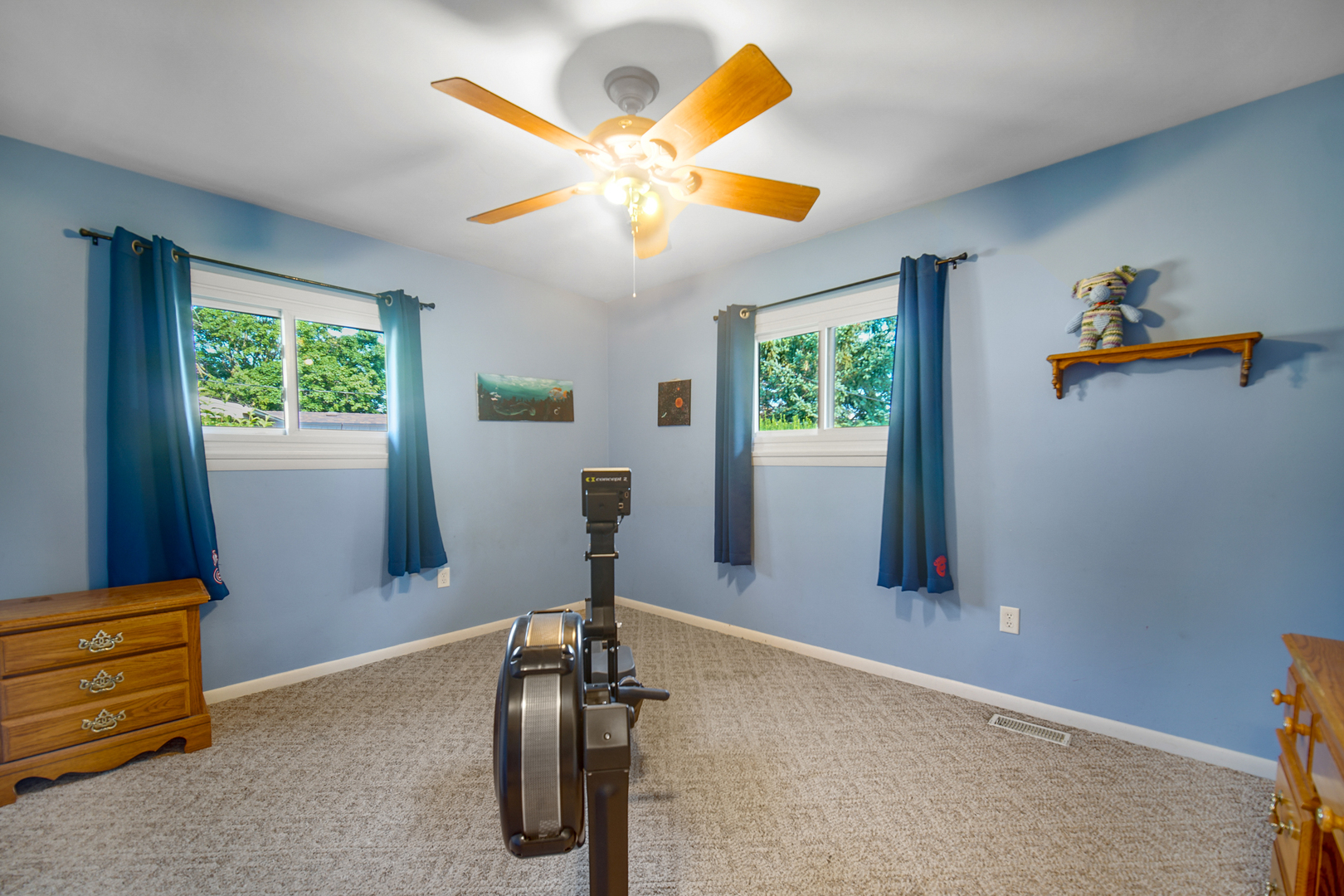 2296 185th Place Lansing, IL 60438 - Photo 18 of 32 a view of a room with gym equipment and a large window