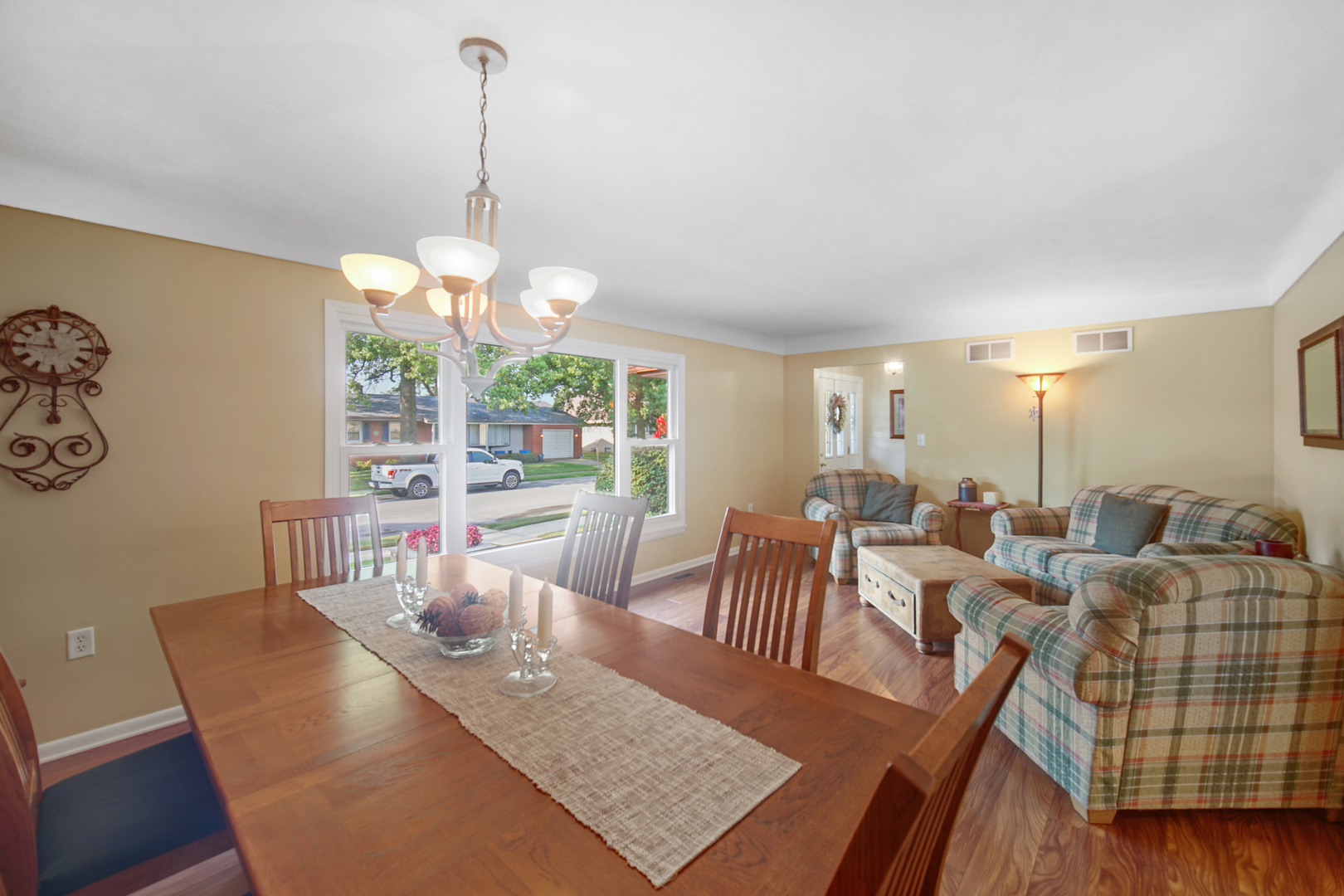 2296 185th Place Lansing, IL 60438 - Photo 7 of 32 a view of a dining room with furniture a chandelier and wooden floor