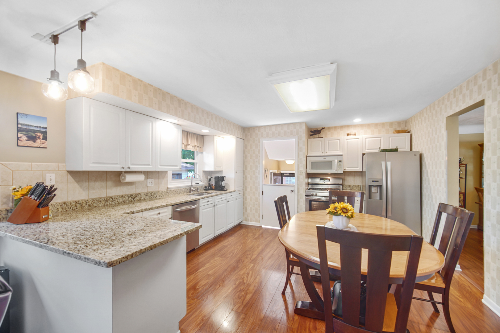 2296 185th Place Lansing, IL 60438 - Photo 8 of 32 a kitchen with a dining table chairs and refrigerator