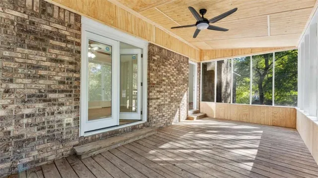 a view of a livingroom with wooden floor and a ceiling fan
