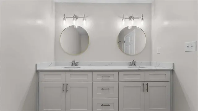 a bathroom with 2 sink and a mirror