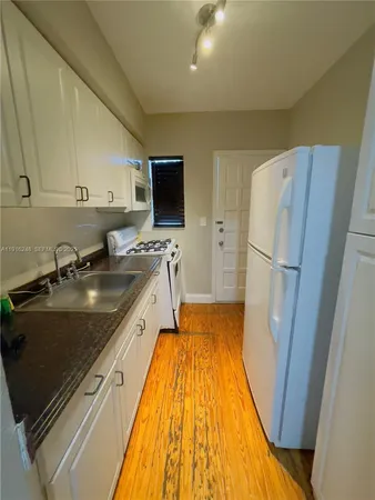a kitchen with a sink appliances and cabinets