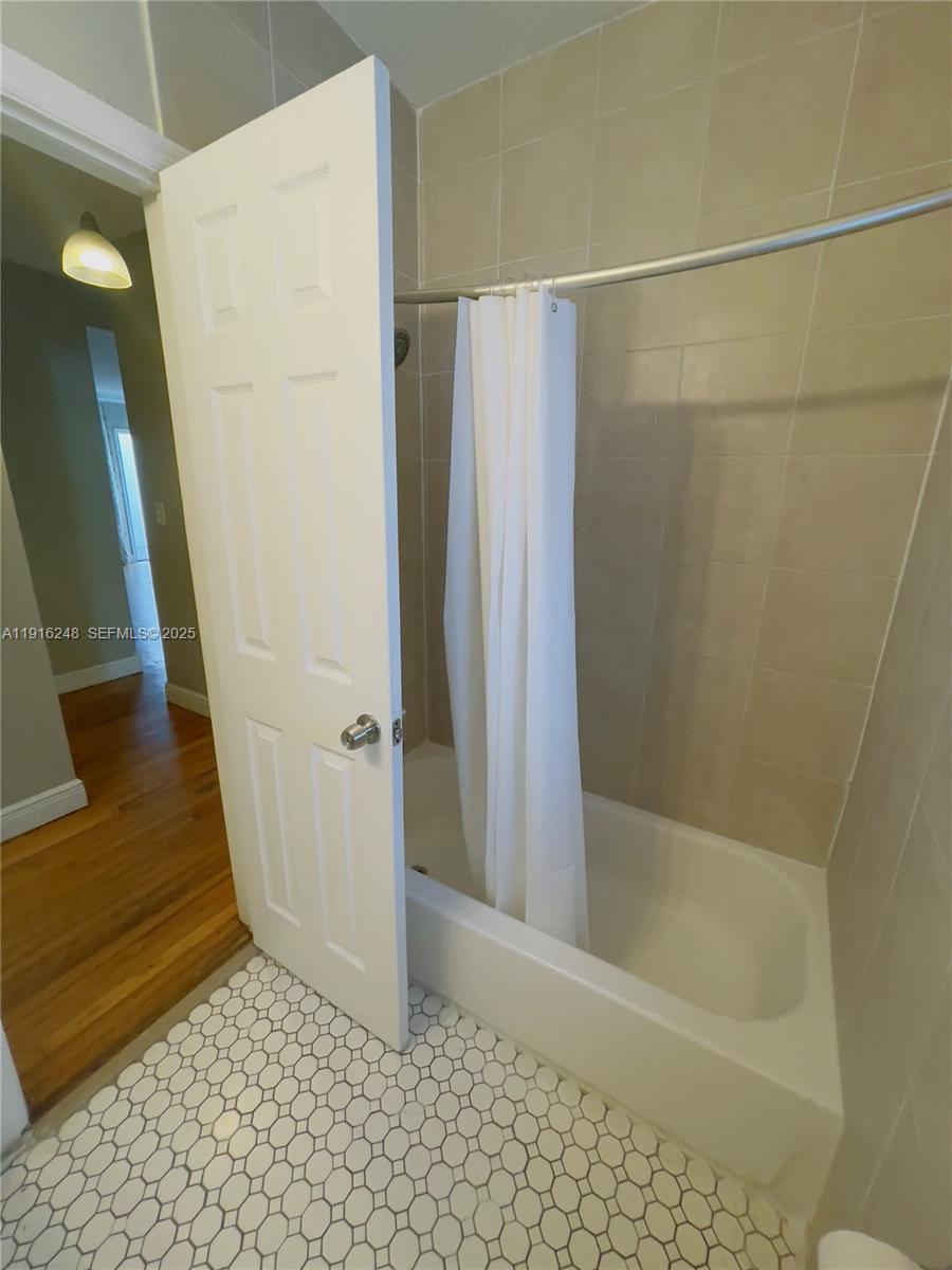 7710 Harding Avenue, Unit 412 Miami Beach, FL 33141 - Photo 7 of 8 a bathroom with a shower
