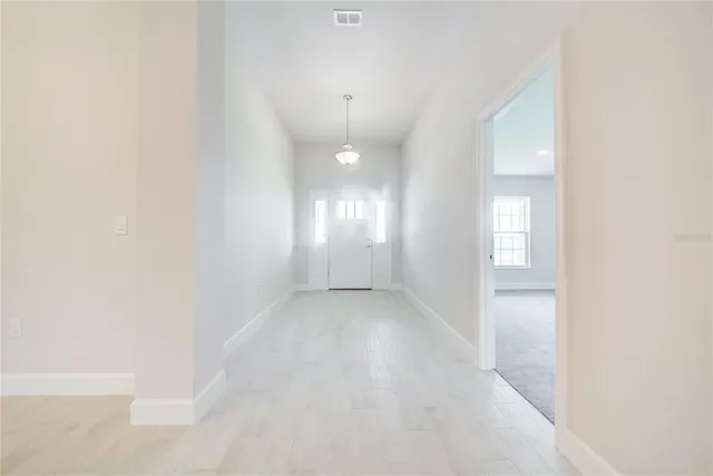 an empty room with kitchen view and appliances