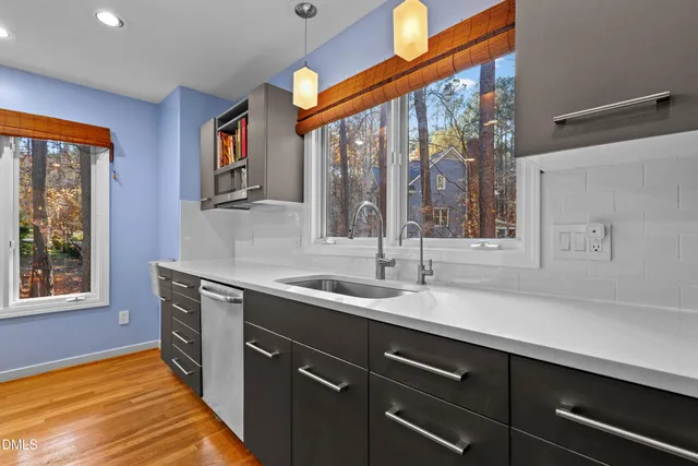 a large kitchen with stainless steel appliances granite countertop a refrigerator a oven a sink and dishwasher