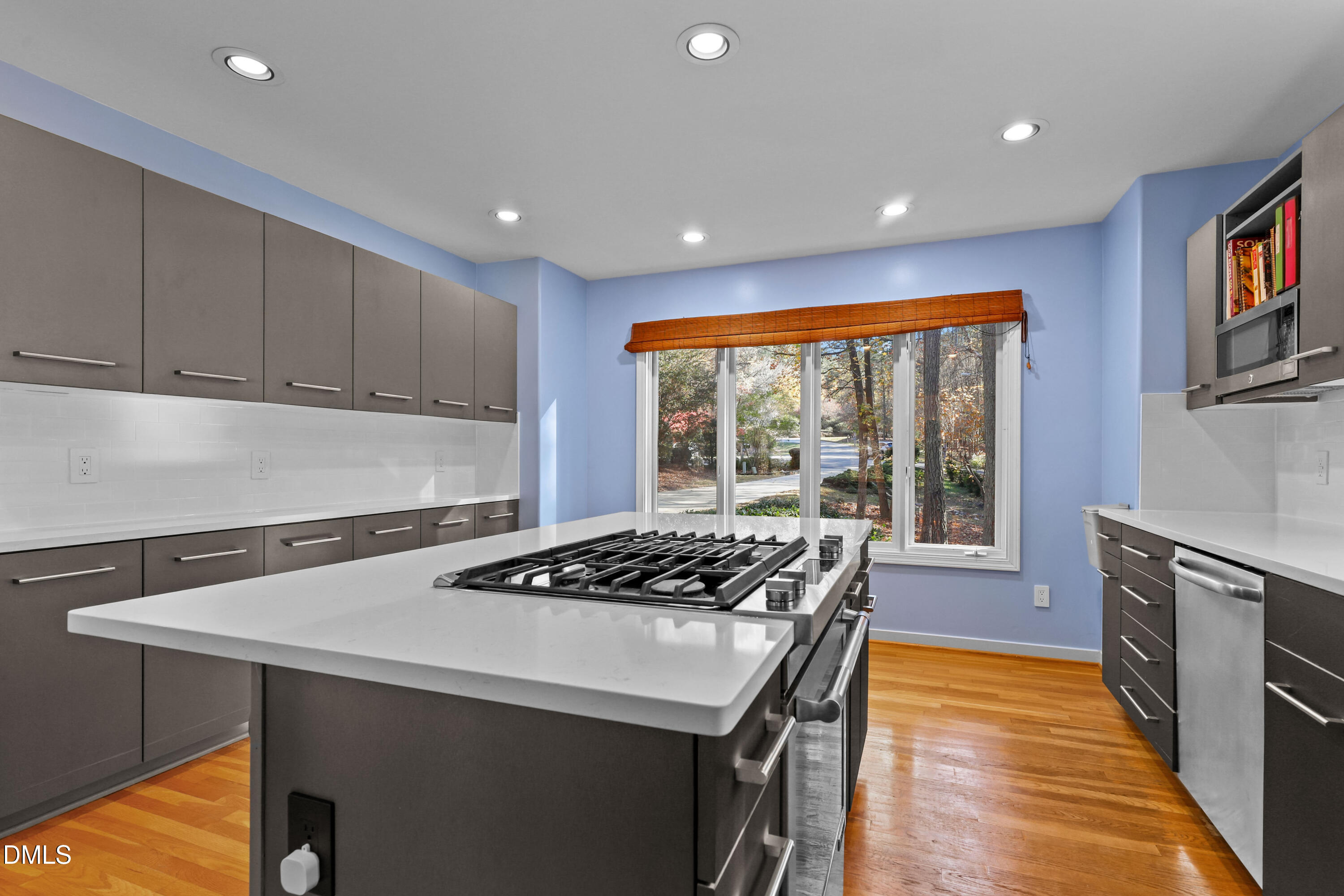 2617 Scarlet Sage Court Raleigh, NC 27613 - Photo 12 of 78 a kitchen with stainless steel appliances granite countertop a stove a sink a refrigerator white cabinets and wooden floor