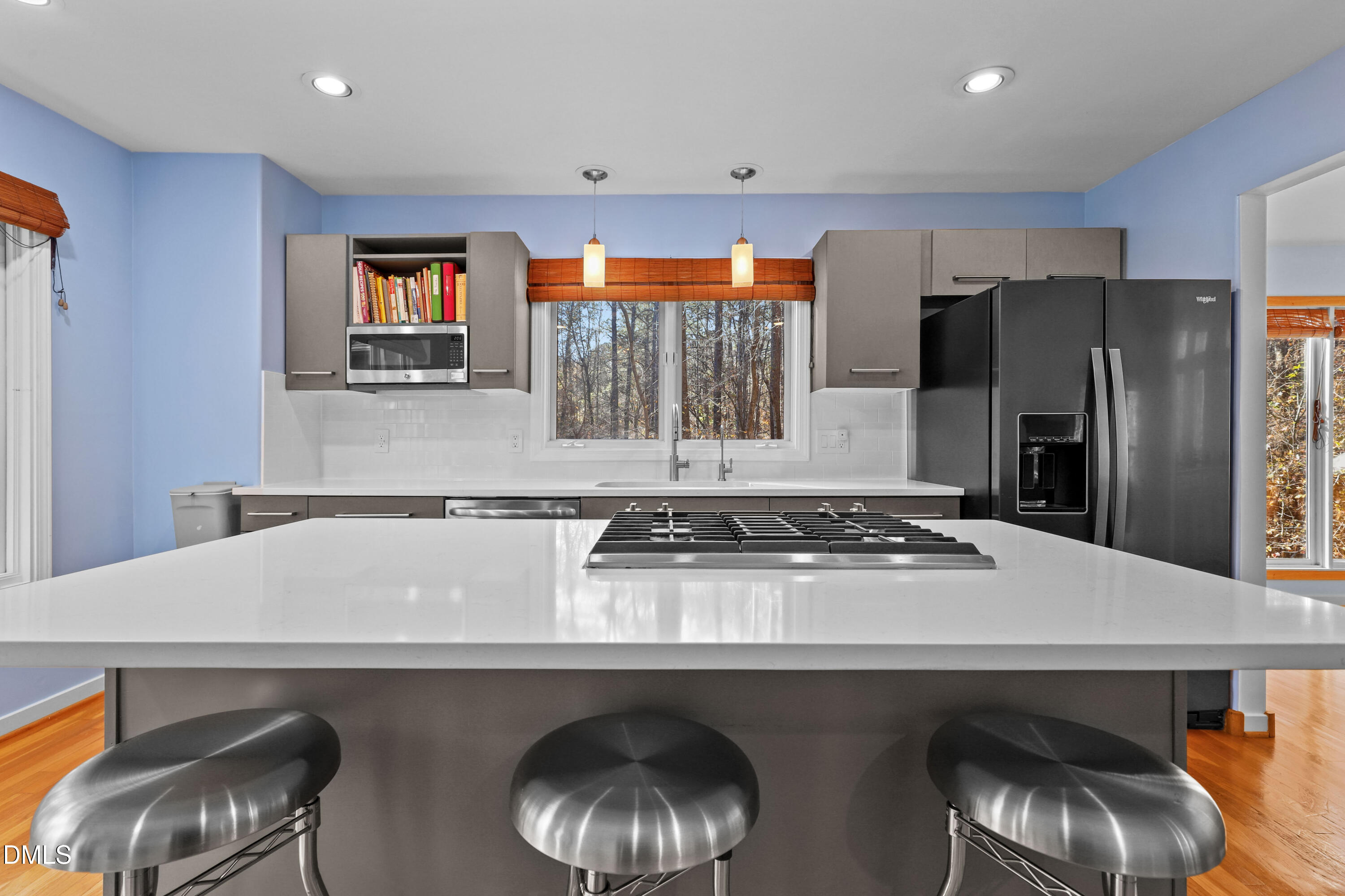 2617 Scarlet Sage Court Raleigh, NC 27613 - Photo 15 of 78 a kitchen with stainless steel appliances a table and chairs in it