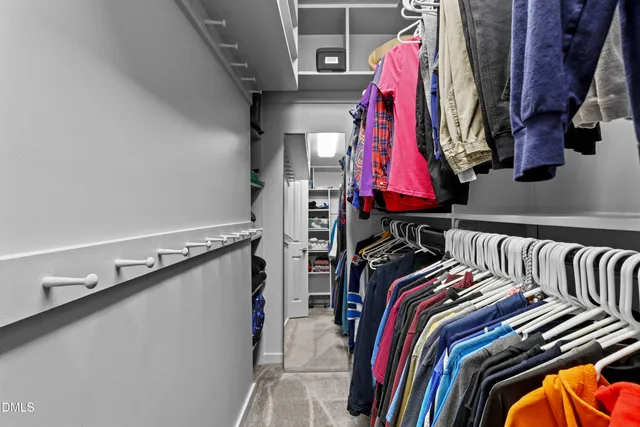 a living room with furniture a flat screen tv and a window