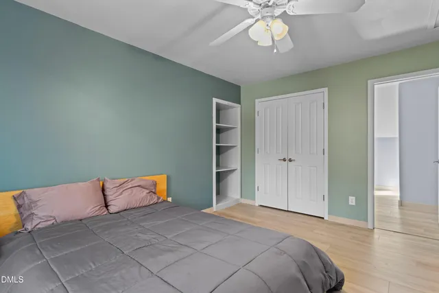a view of a livingroom with wooden floor and a ceiling fan