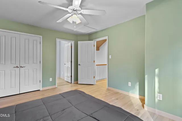 an empty room with wooden floor and closet