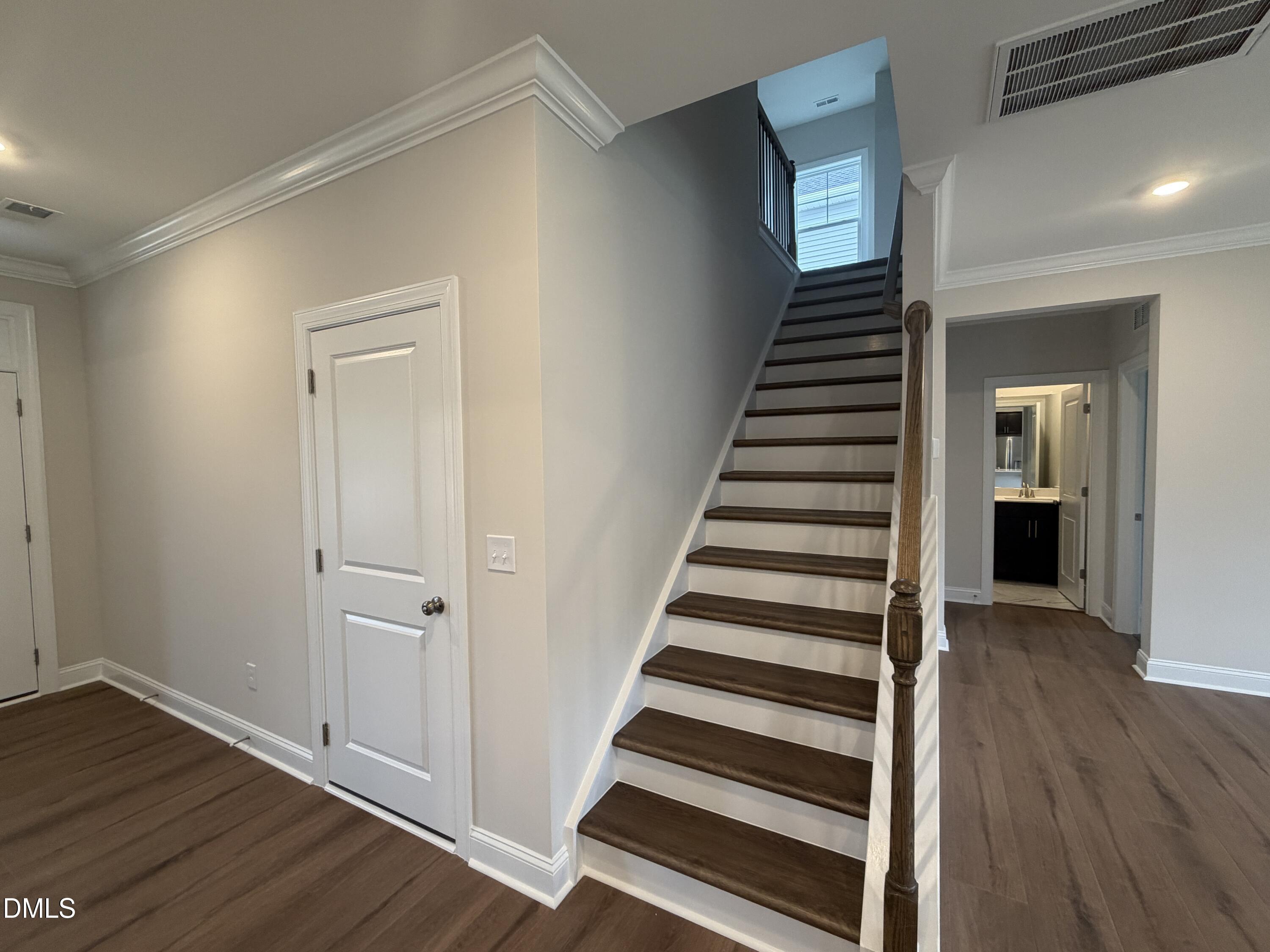 4210 Gray Alder Lane Raleigh, NC 27616 - Photo 11 of 31 a view of a hallway with wooden floor and entryway