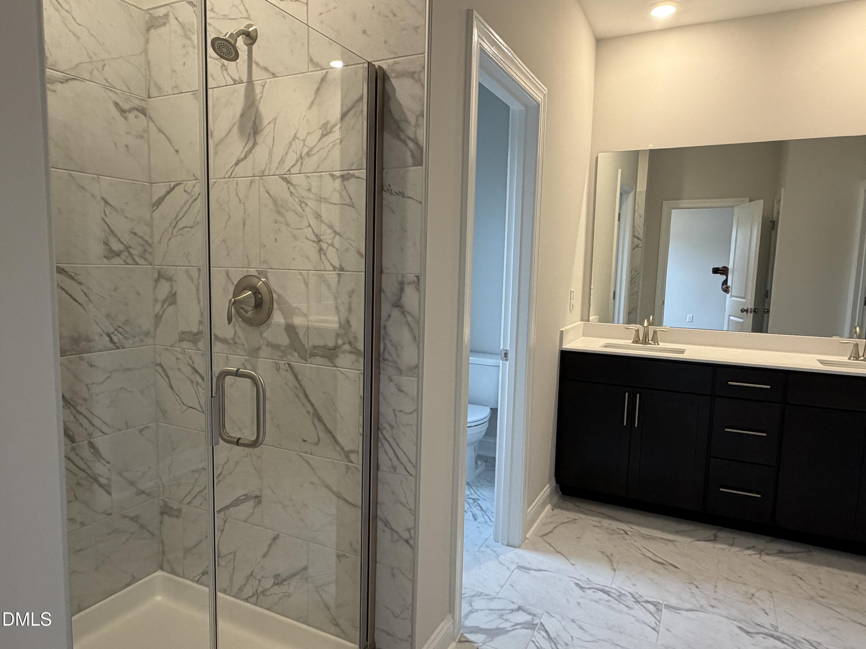 4210 Gray Alder Lane Raleigh, NC 27616 - Photo 15 of 31 a bathroom with a double vanity sink and mirror