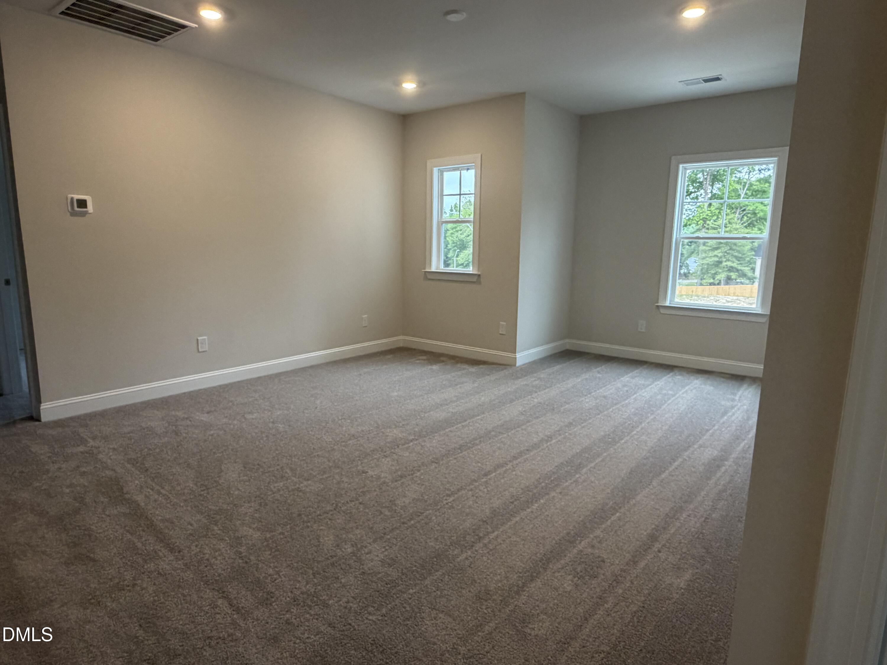 4210 Gray Alder Lane Raleigh, NC 27616 - Photo 20 of 31 an empty room with wooden floor and windows