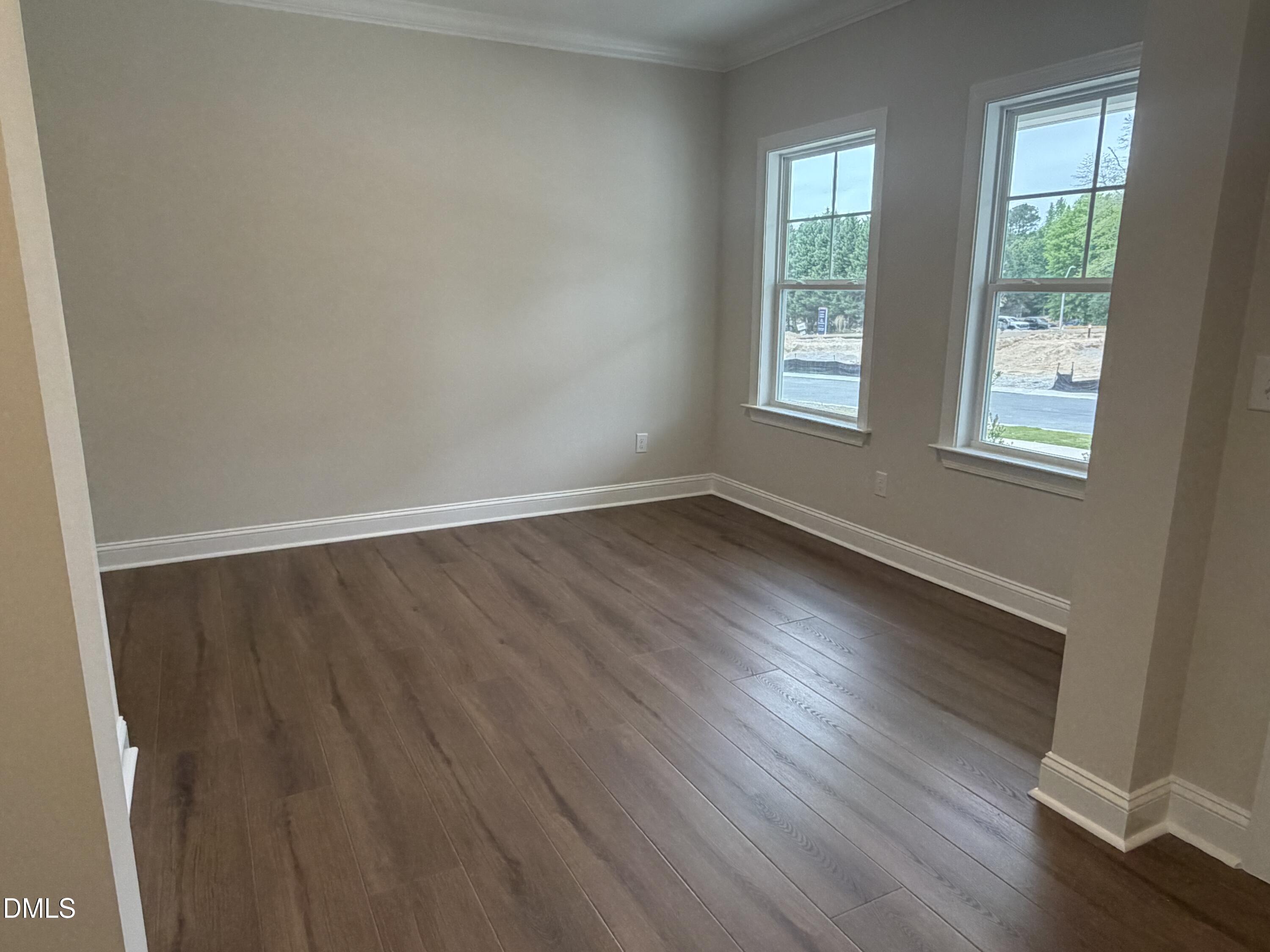 4210 Gray Alder Lane Raleigh, NC 27616 - Photo 3 of 31 an empty room with wooden floor and windows