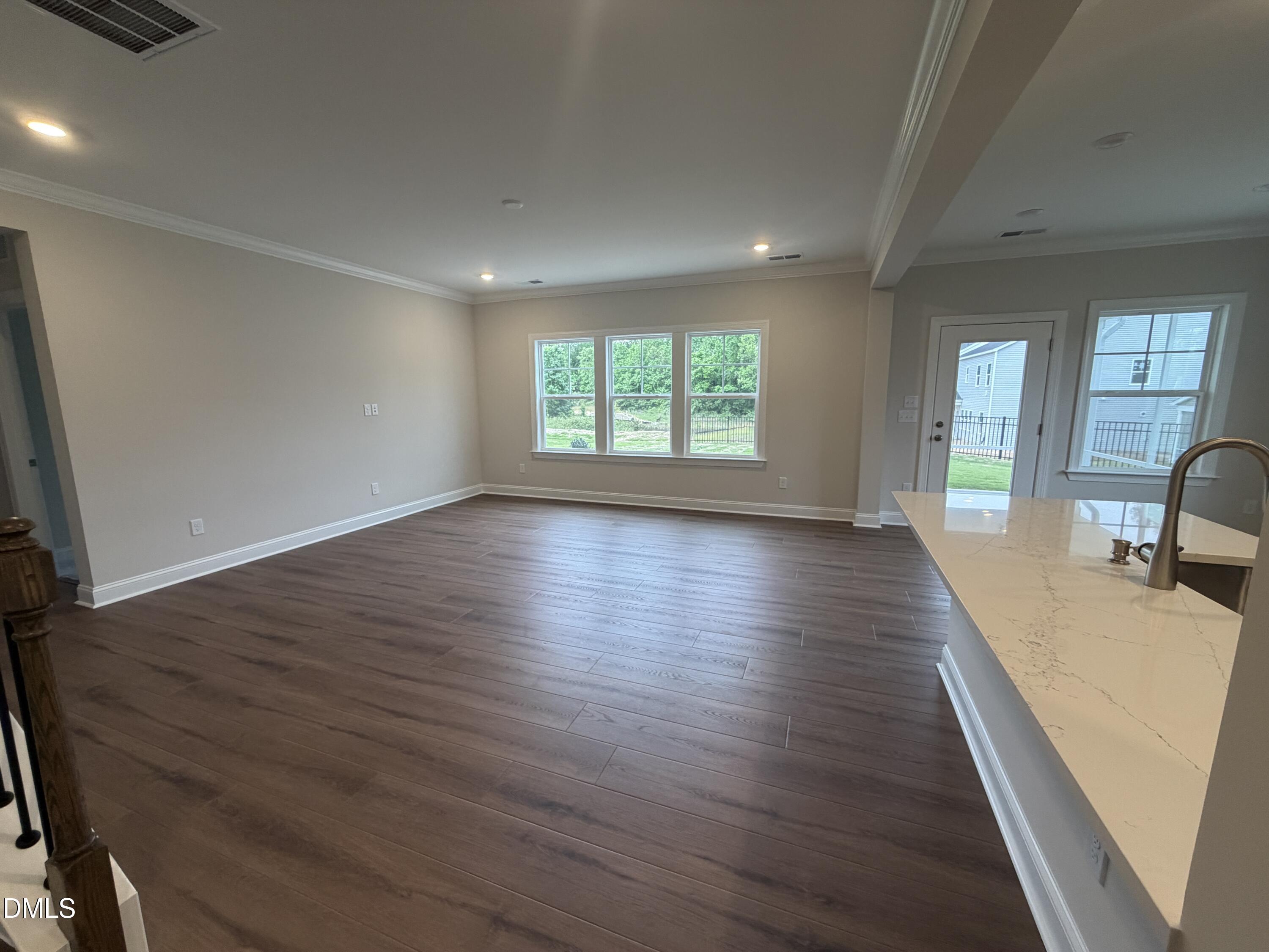 4210 Gray Alder Lane Raleigh, NC 27616 - Photo 8 of 31 an empty room with wooden floor and windows