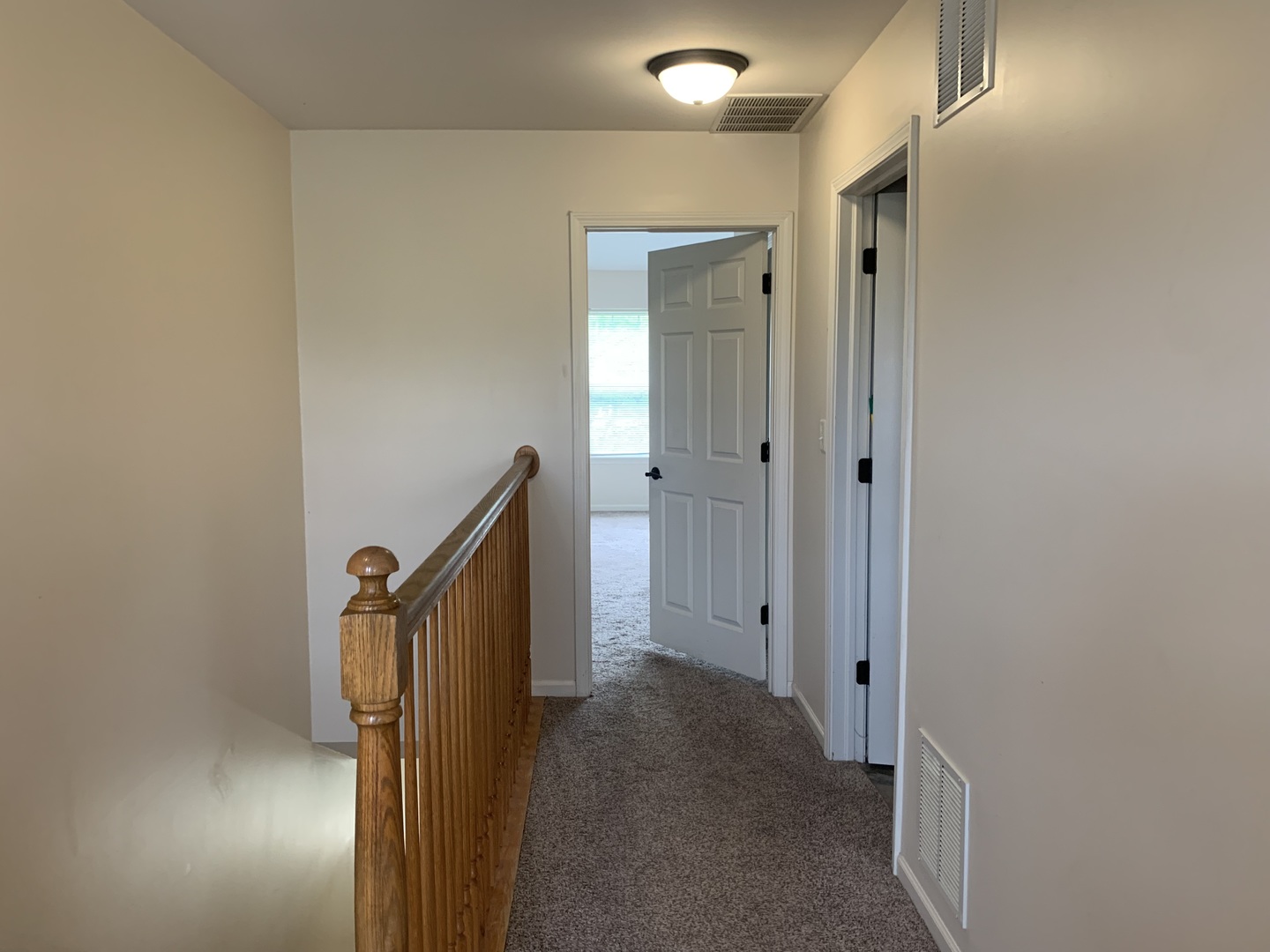 909 Genesee Drive Naperville, IL 60563 - Photo 11 of 26 a view of a hallway with closet and wooden floor