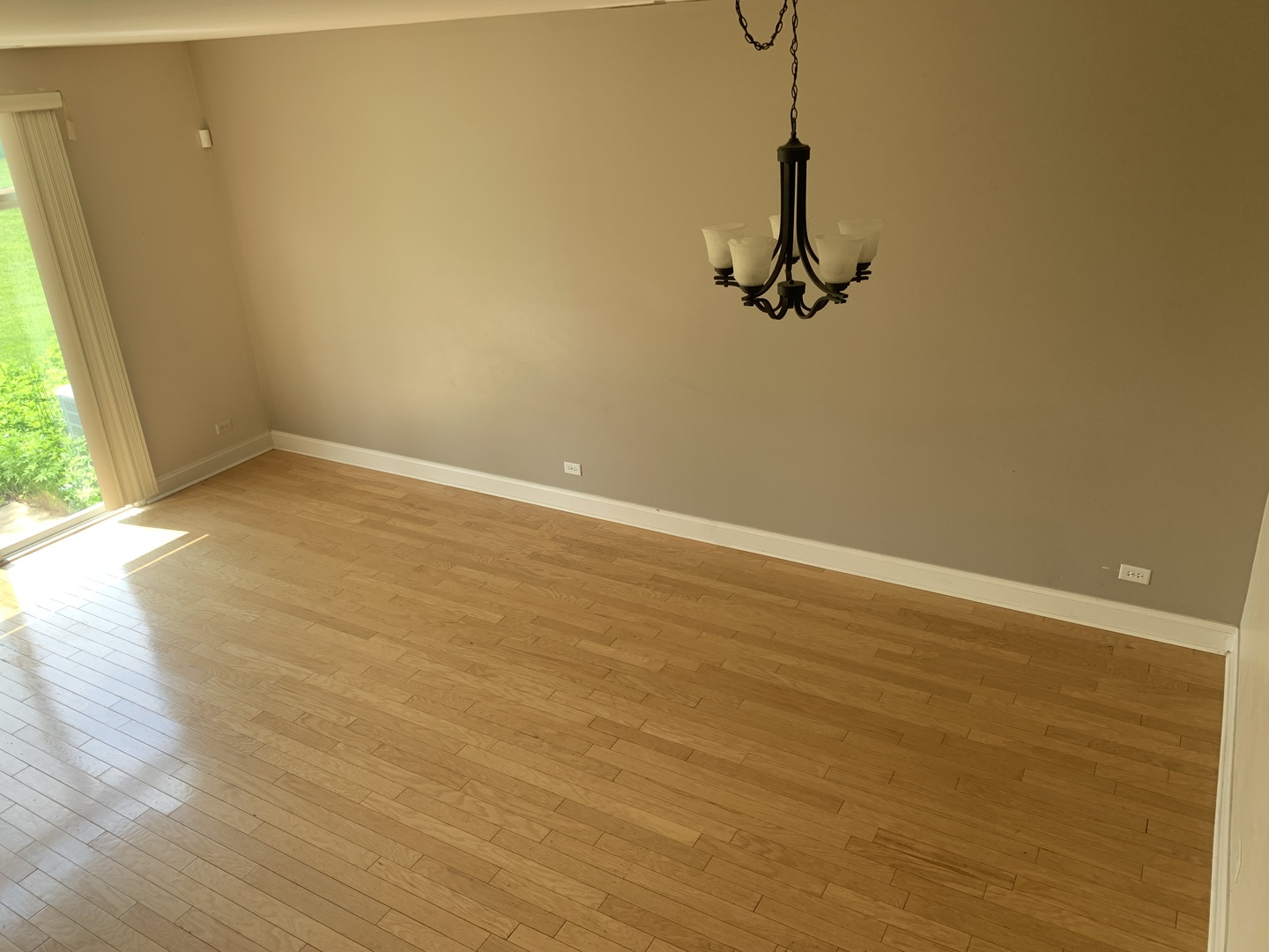 909 Genesee Drive Naperville, IL 60563 - Photo 6 of 26 a view of a room with wooden floor and windows