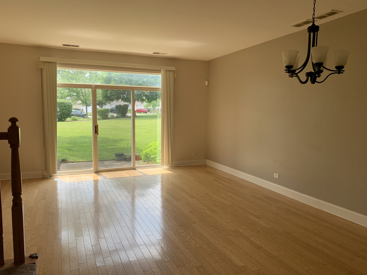 909 Genesee Drive Naperville, IL 60563 - Photo 7 of 26 a view of an empty room with wooden floor and a window