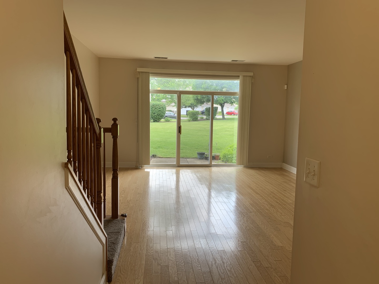 909 Genesee Drive Naperville, IL 60563 - Photo 8 of 26 a view of a hallway with wooden floor and staircase