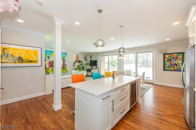 a view of a dining room with furniture a rug and wooden floor