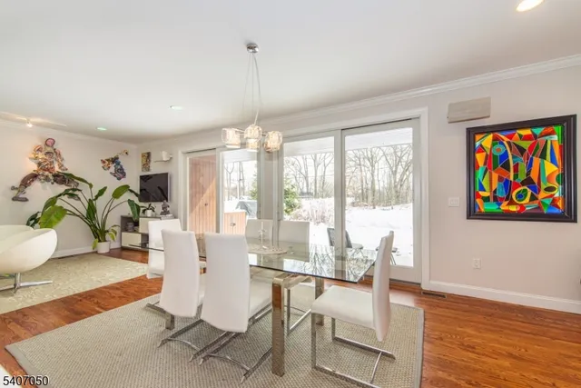 a living room with dining room and wooden floor