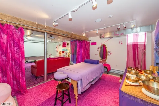 a living room with a bed furniture and a window