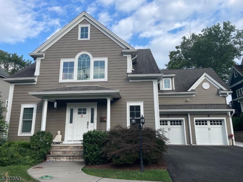 8 Madison Avenue Montclair, NJ 07042 - Photo 3 of 49 a front view of a house with a yard and garage