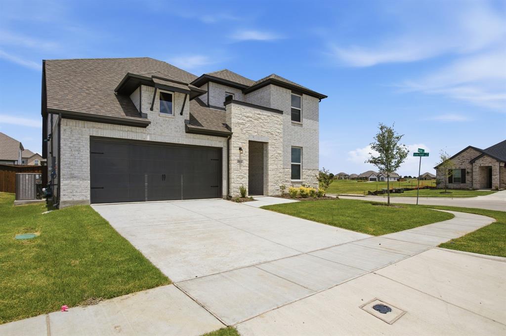 2911 Hanscom Street Forney, TX 75126 - Photo 14 of 40 Contemporary two-story residence featuring light brick and stone facade accents