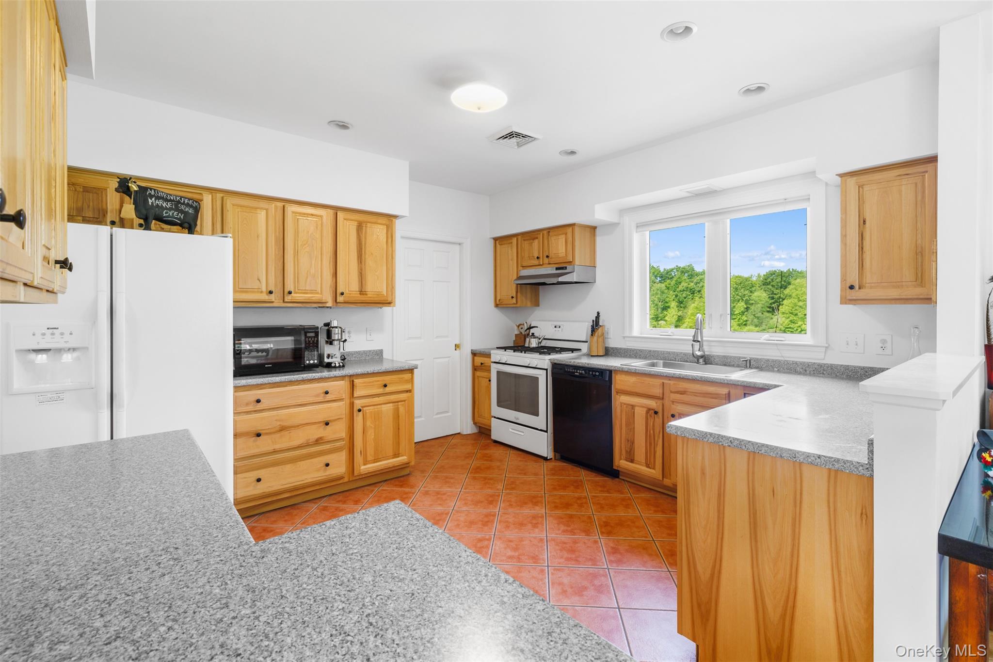 508 Woodstock Road Millbrook, NY 12545 - Photo 16 of 46 a kitchen with stainless steel appliances kitchen island granite countertop a stove a sink and a refrigerator