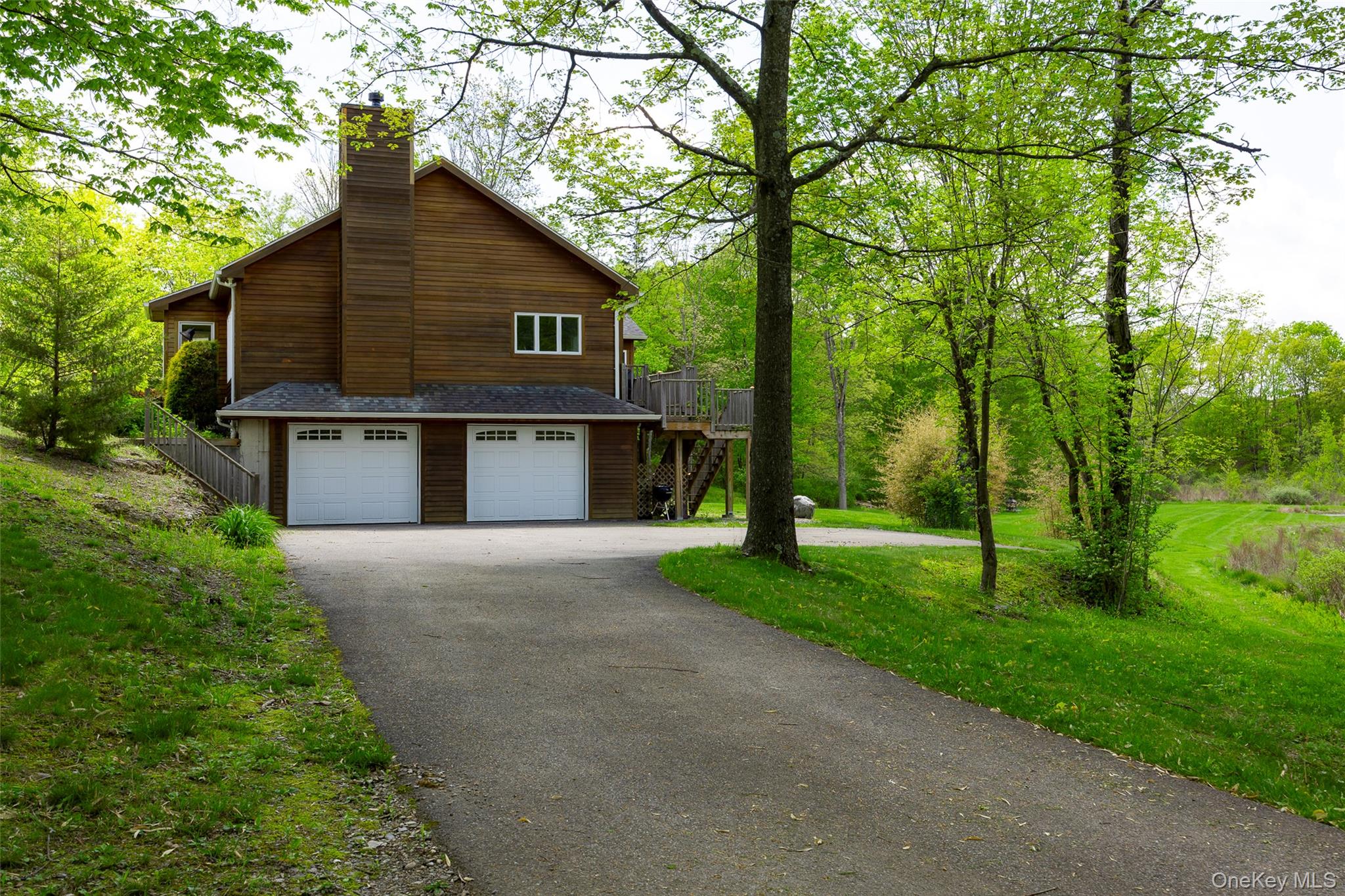 508 Woodstock Road Millbrook, NY 12545 - Photo 26 of 46 a view of a house with a yard and a large tree