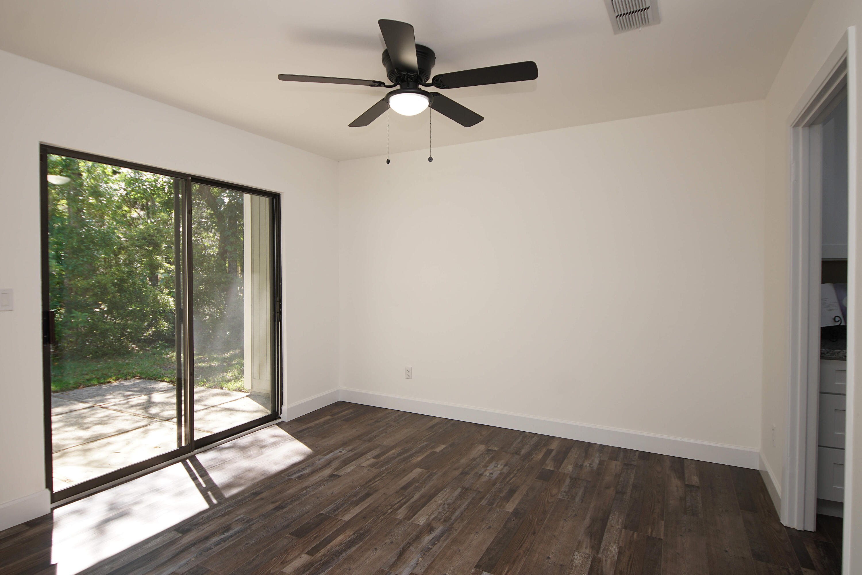 800 Bay Drive, Unit 8 Niceville, FL 32578 - Photo 19 of 29 wooden floor in an empty room with a window