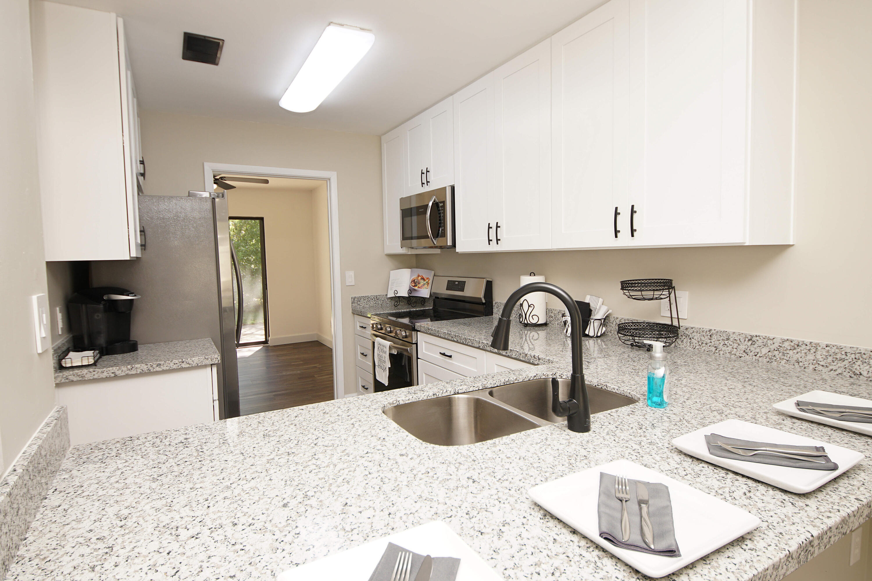800 Bay Drive, Unit 8 Niceville, FL 32578 - Photo 2 of 29 a kitchen with stainless steel appliances granite countertop a sink and a stove