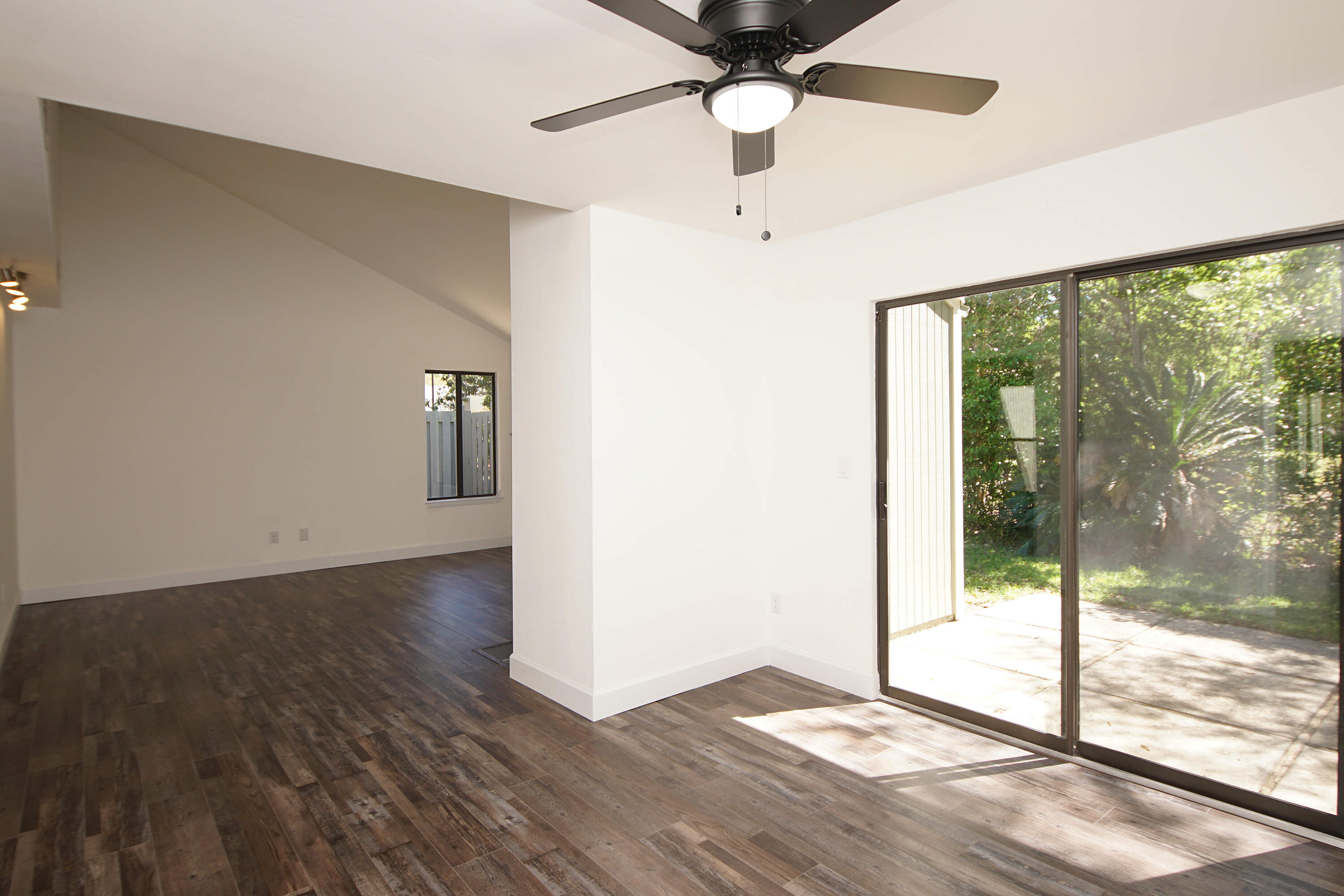 800 Bay Drive, Unit 8 Niceville, FL 32578 - Photo 21 of 29 an empty room with wooden floor and windows