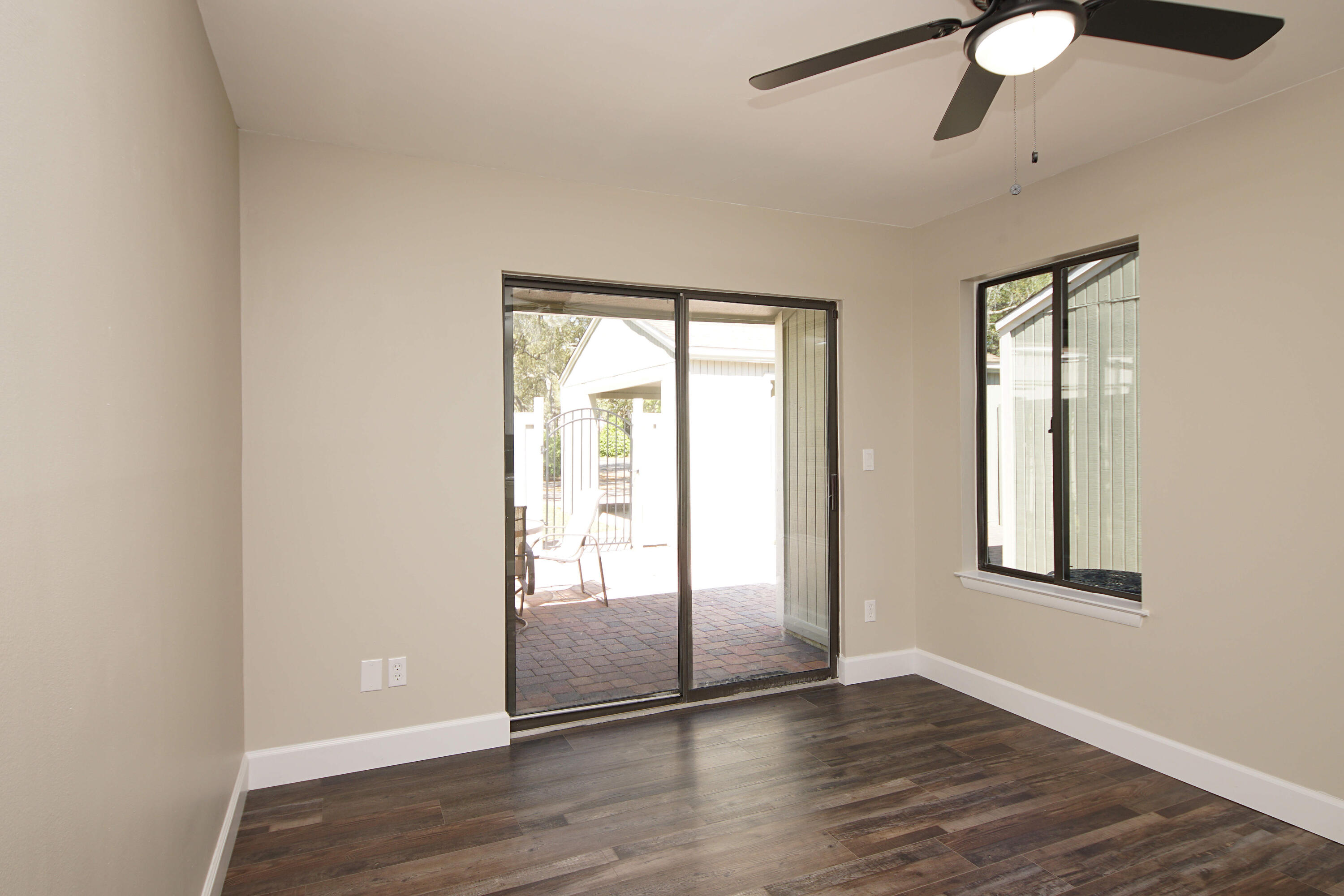 800 Bay Drive, Unit 8 Niceville, FL 32578 - Photo 24 of 29 an empty room with wooden floor chandelier and windows