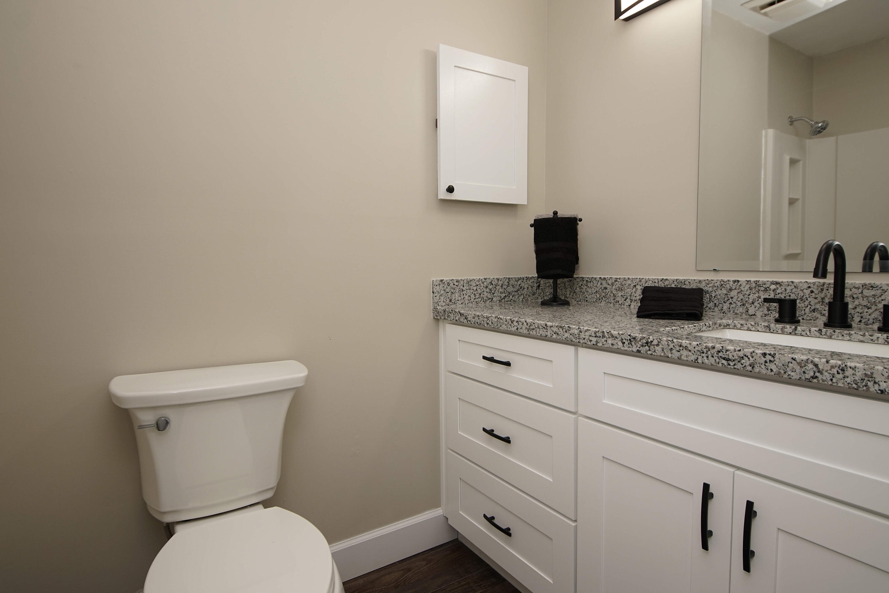 800 Bay Drive, Unit 8 Niceville, FL 32578 - Photo 27 of 29 a bathroom with a granite countertop toilet sink and mirror