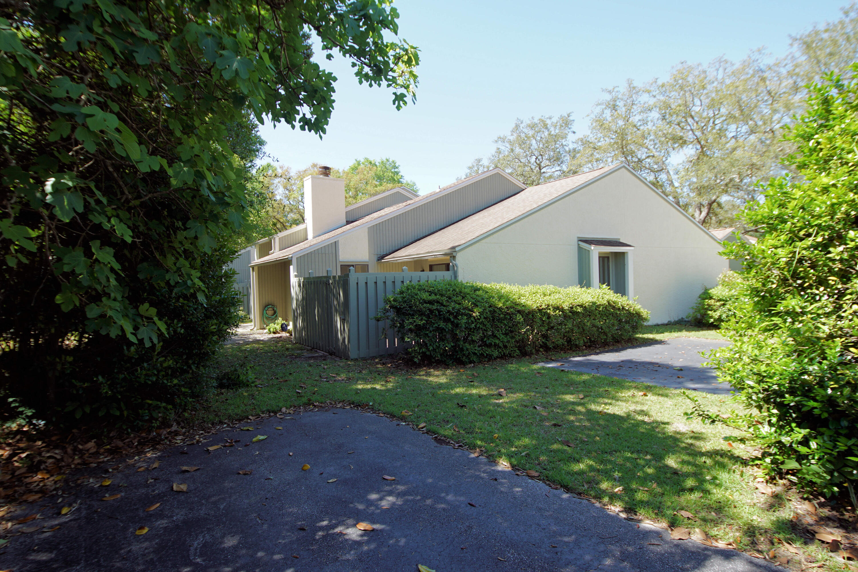 800 Bay Drive, Unit 8 Niceville, FL 32578 - Photo 28 of 29 a view of a yard in front of a house with plants and large tree