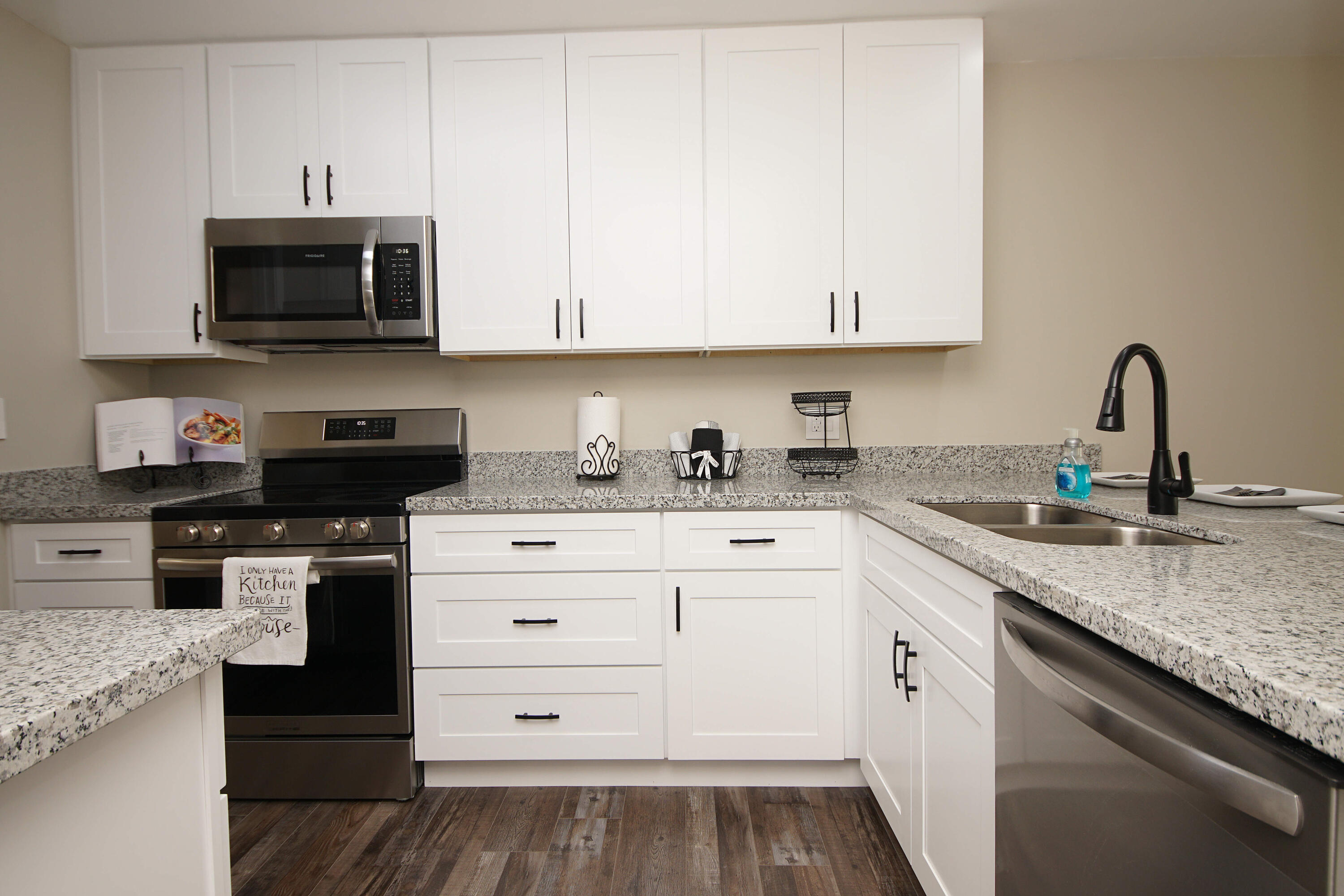 800 Bay Drive, Unit 8 Niceville, FL 32578 - Photo 4 of 29 a kitchen with granite countertop white cabinets and stainless steel appliances