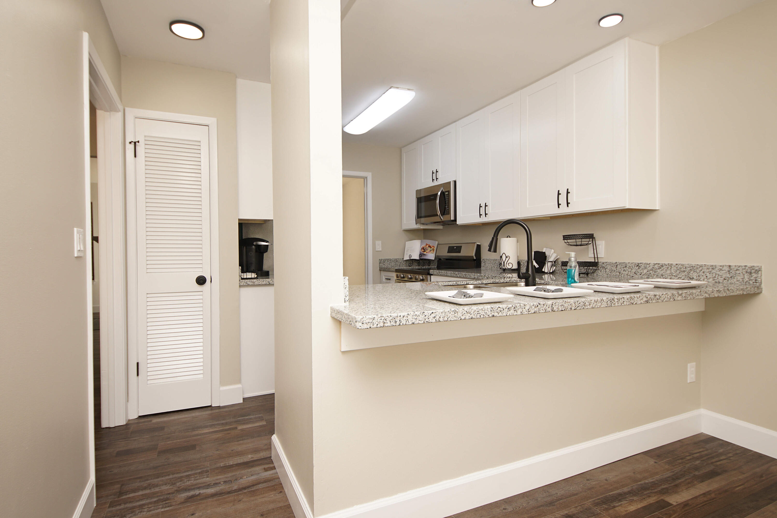 800 Bay Drive, Unit 8 Niceville, FL 32578 - Photo 5 of 29 a kitchen with stainless steel appliances granite countertop a refrigerator sink and stove