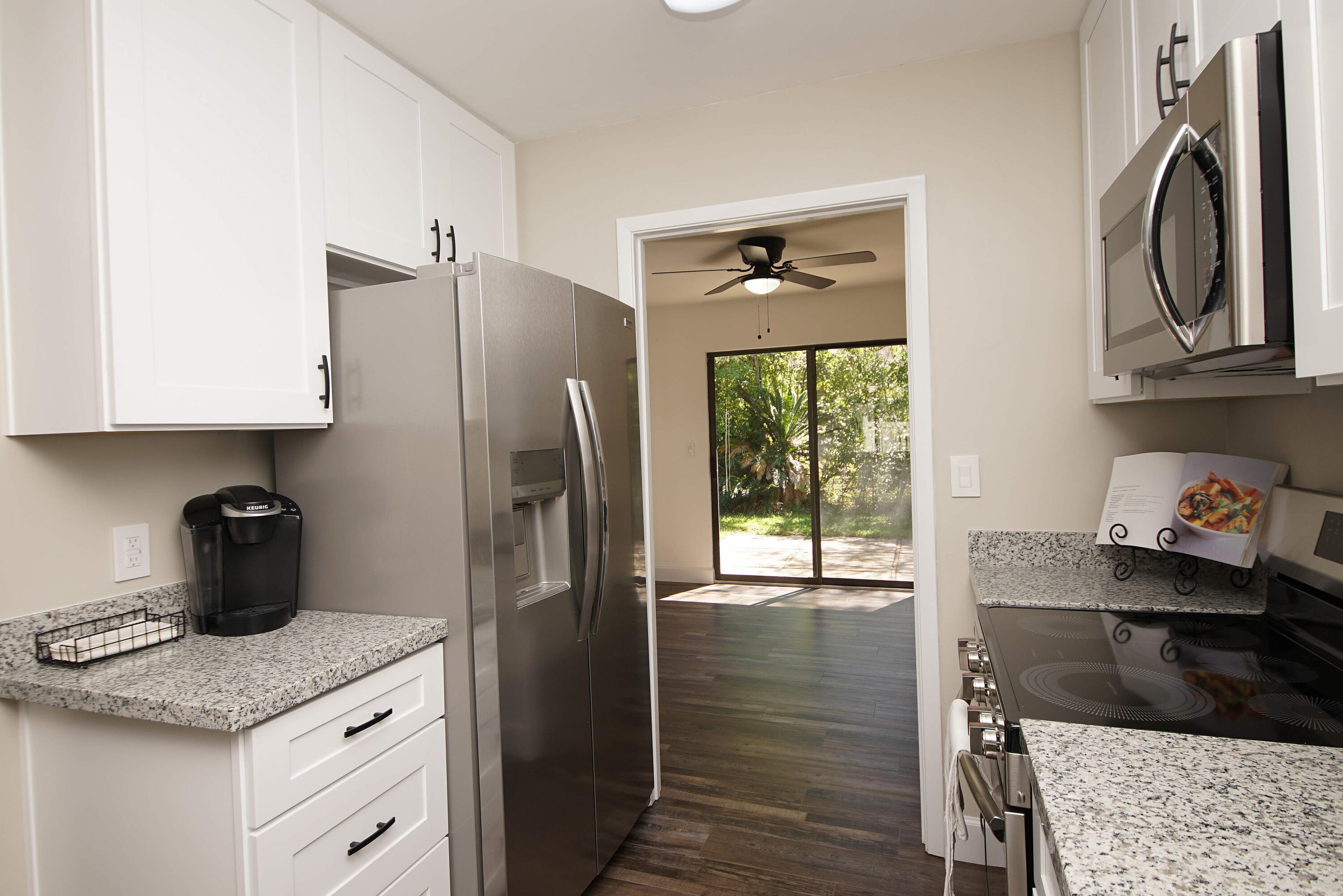 800 Bay Drive, Unit 8 Niceville, FL 32578 - Photo 6 of 29 a kitchen with stainless steel appliances granite countertop a refrigerator a stove and a sink with wooden floor