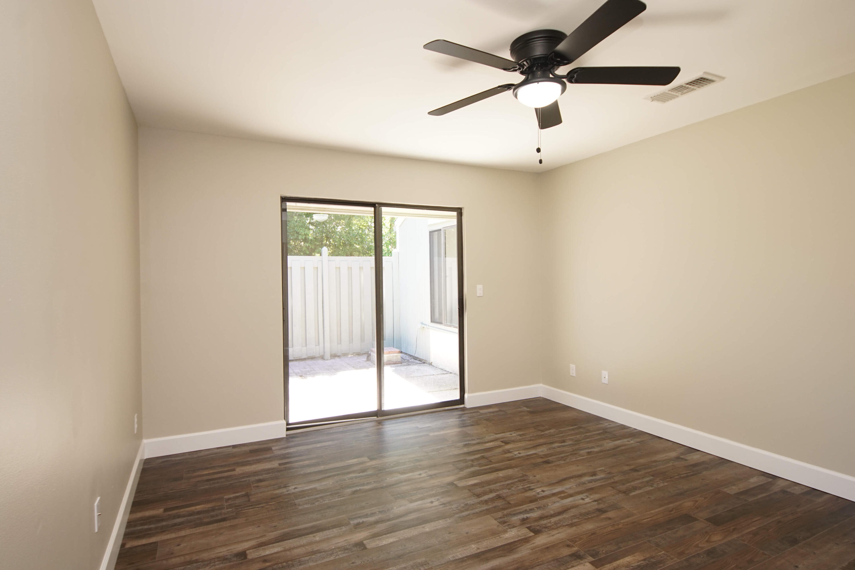 800 Bay Drive, Unit 8 Niceville, FL 32578 - Photo 9 of 29 an empty room with wooden floor ceiling fan and window